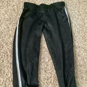 black athletic pants with stripes on sides